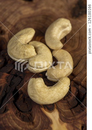 cashew are scattered on a board, cashew nuts are healthy and allowed for vegans. , top view 126180166