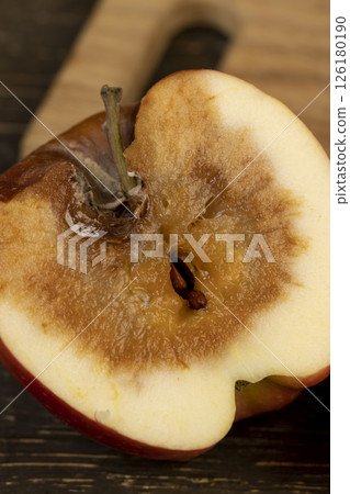 one rotting apple on the table 126180190