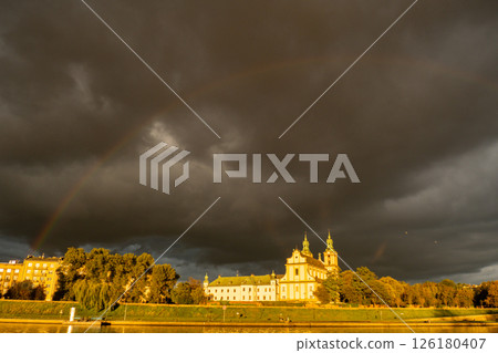 Heavy rain and rainbow above the Vistula river in Krakow Poland. Stunning views of the city rainy season and rainbow 126180407