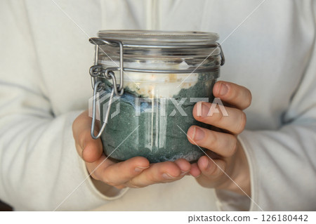 Unrecognizable woman eating Glass jar with natural organic homemade yogurt and blueberries spirulina chlorella superfood super powder blue algae sea weed. Immunity-boosting ingredients. Concept of Unrecognizable woman eating Glass jar with natural organic homemade yogurt and blueberries spirulina chlorella superfood super powder blue algae sea weed. Immunity-boosting ingredients. Concept of 126180442
