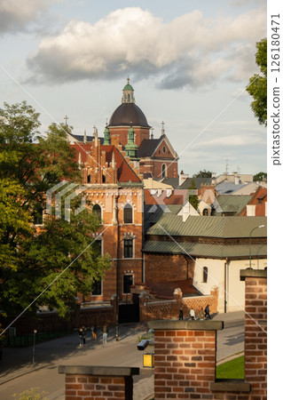 Summer view of Wawel Royal Castle in Krakow, Poland. Historical place in Poland. Flowers on foreground. Beautiful sightseeing with Wawel Royal Castle and colorful flowers in Krakow, Poland 126180471