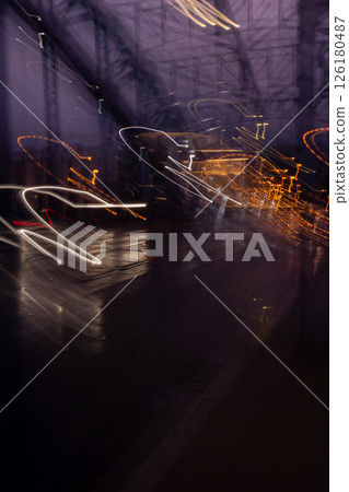 Defocused Lights of cars at night in Krakow bridge. Street line lights. Night highway city. Long exposure photograph night road. Colored bands of red light trails on the road. Background wallpaper  126180487