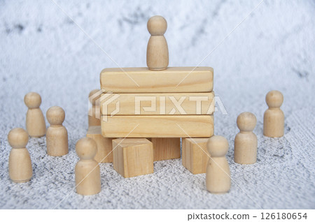 Wooden doll on to of wooden blocks with customizable space for text or ideas. Copy space and leadership concept Wooden doll on to of wooden blocks with customizable space for text or ideas. Copy space and leadership concept 126180654