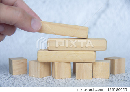 Hand placing wooden blocks with customizable space for text or ideas. Copy space concept Hand placing wooden blocks with customizable space for text or ideas. Copy space concept 126180655