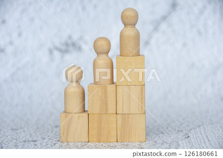 Wooden dolls on a stacking wooden cubes with customizable space for text Wooden dolls on a stacking wooden cubes with customizable space for text 126180661