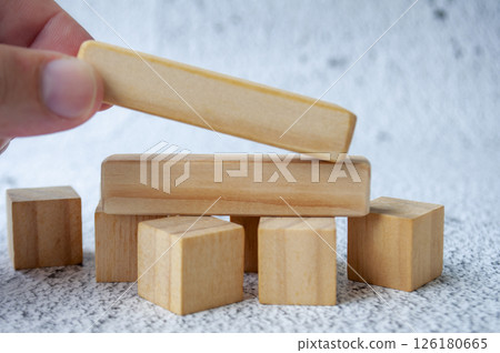 Close up of hand putting a wooden blocks with customizable space for text Close up of hand putting a wooden blocks with customizable space for text 126180665