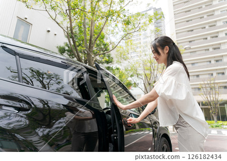 A young lady descending from the car A young lady descending from the car 126182434