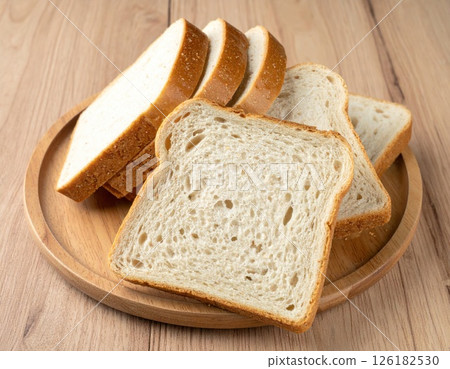 Five Slices of White Bread on a Wooden Plate 126182530