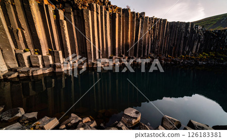 Basalt columns by the river landscape .Background concept. Generated Image 126183381