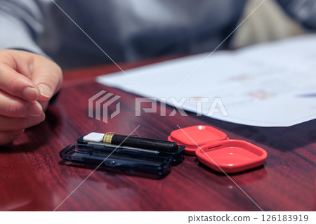 A housewife carefully reading the contract A housewife carefully reading the contract 126183919