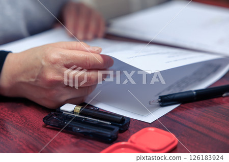 A housewife carefully reading the contract A housewife carefully reading the contract 126183924