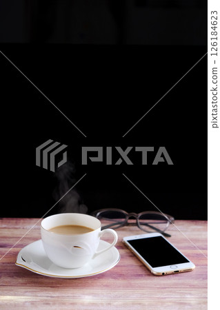 Coffee, smartphone and glasses on the table Coffee, smartphone and glasses on the table 126184623