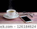 Steaming coffee, glasses and smartphone 126184624