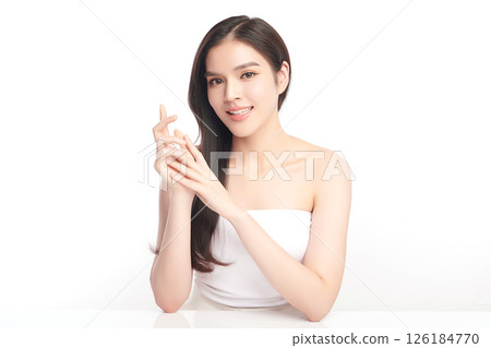 A beautiful young Asian woman with clean, fresh skin against a white background. Skincare, facial treatment, cosmetology, beauty, and spa. An elegant portrait of an Asian woman. 126184770