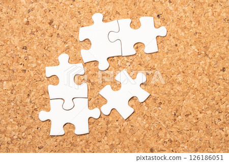 Cork board and white puzzle pieces Cork board and white puzzle pieces 126186051