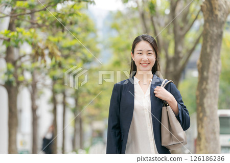 Business woman walking outdoors Business woman walking outdoors 126186286