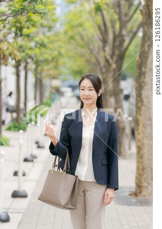 Business woman walking outdoors Business woman walking outdoors 126186295