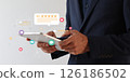Businessman using hand on tablet with floating digital review icons. 126186502