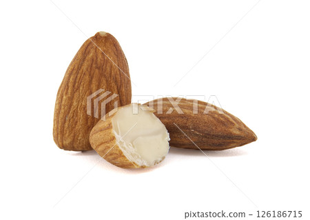 Close-up of three almonds, one cut open, set against a clean, white backdrop. Close-up of three almonds, one cut open, set against a clean, white backdrop. 126186715