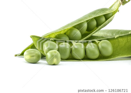 A close-up shot of fresh, green peas in a pod, isolated on a white backdrop. A close-up shot of fresh, green peas in a pod, isolated on a white backdrop. 126186721