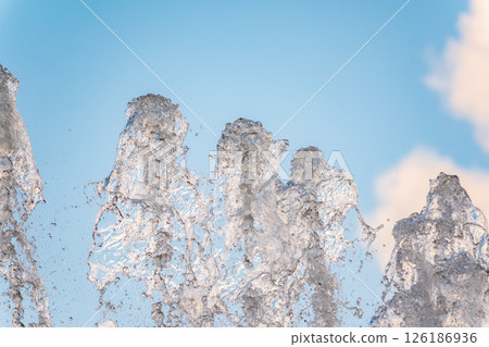 Splashes and jets of water against light background. 126186936