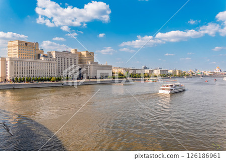 View of the Ministry of Defence of Russian Federation, and Moscow river embankment with cruise ships at sunset. 126186961