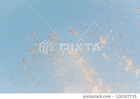 Splashes and jets of water against light background. Splashes and jets of water against light background. 126187735