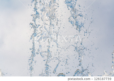Splashes and jets of water against light background. Splashes and jets of water against light background. 126187739