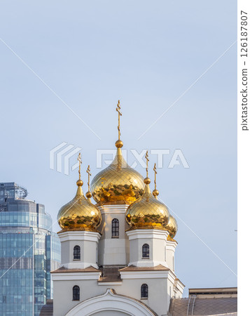 The golden domes of the Christian church in sunset light. The golden domes of the Christian church in sunset light. 126187807