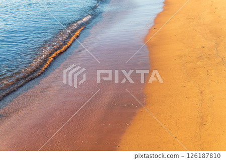 Soft wave of the sea on the sandy beach. 126187810