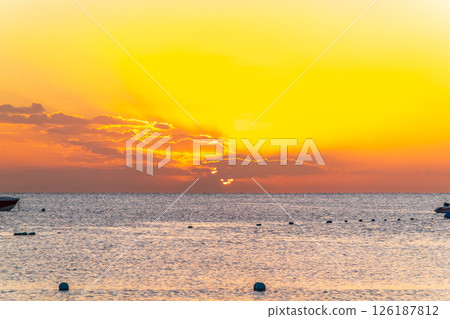 Beautiful yellow and orange sunrise over the sea. 126187812