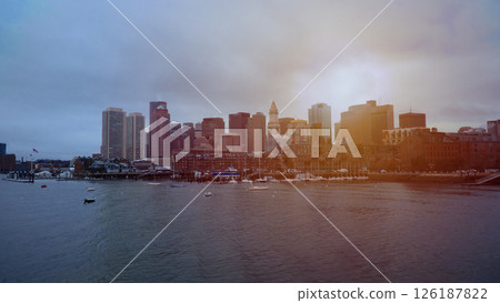 Boston skyline reflecting on water during sunset with cloudy sky Boston skyline reflecting on water during sunset with cloudy sky 126187822