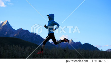 Fitness woman trail runner running on grassland mountain top 126187922