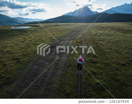 Aerial view of woman trail runner in high altitude mountains 126187934