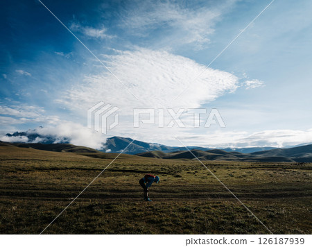 Aerial view of woman trail runner in high altitude mountains 126187939