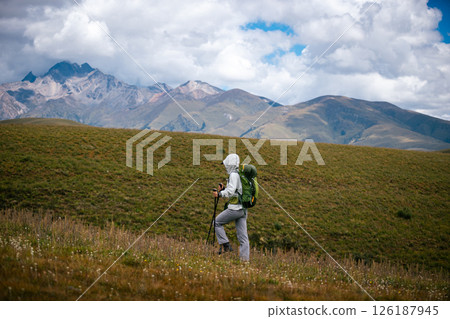 Woman backpacker hiking on high altitude mountains 126187945