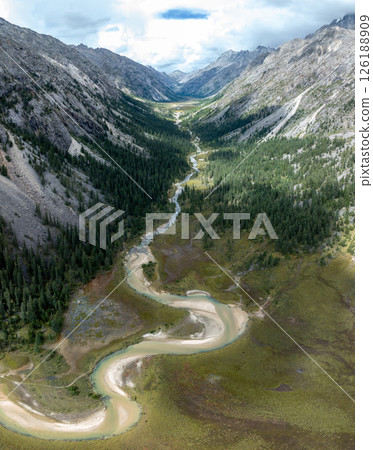 Aerial view of beautiful high altitude forest canyon and snow capped mountain landscape Aerial view of beautiful high altitude forest canyon and snow capped mountain landscape 126188909