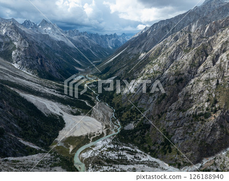 Aerial view of beautiful high altitude forest canyon and snow capped mountain landscape Aerial view of beautiful high altitude forest canyon and snow capped mountain landscape 126188940