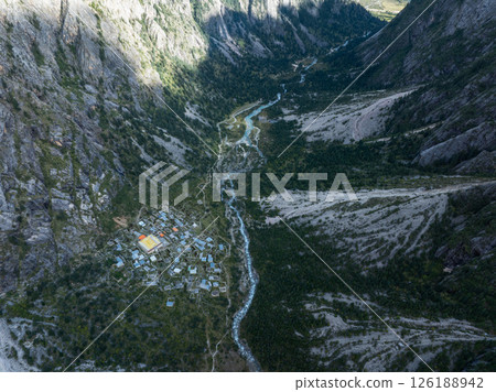 Aerial view of beautiful high altitude forest canyon and snow capped mountain landscape 126188942