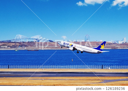 A passenger plane taking off from Haneda Airport, Tokyo Gate Bridge, and Kasai Rinkai Park A passenger plane taking off from Haneda Airport, Tokyo Gate Bridge, and Kasai Rinkai Park 126189236