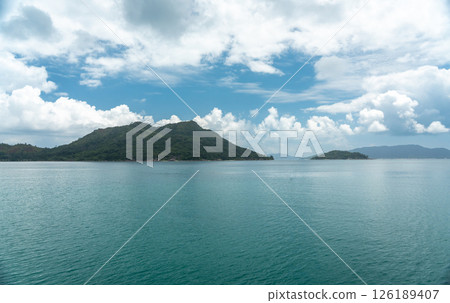 Tropical view of Praslin Island from a ferry in Seychelles, featuring clear ocean, blue sky 126189407