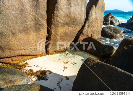 Massive granite boulders and white sand create a tropical beach landscape on La Digue island Massive granite boulders and white sand create a tropical beach landscape on La Digue island 126189454