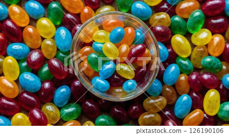 Lots of jelly beans and a round glass bowl 126190106
