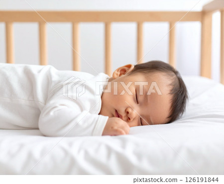 Baby sleeping in a baby bed Baby sleeping in a baby bed 126191844
