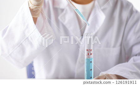 Hands Performing Scientific Experiments in a Modern Laboratory Setting. 126191911