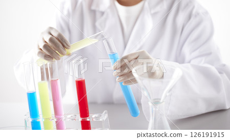 Hands Performing Scientific Experiments in a Modern Laboratory Setting. Hands Performing Scientific Experiments in a Modern Laboratory Setting. 126191915