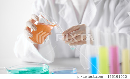 Hands Performing Scientific Experiments in a Modern Laboratory Setting. Hands Performing Scientific Experiments in a Modern Laboratory Setting. 126191920
