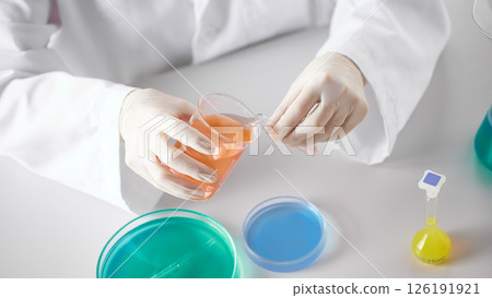 Hands Performing Scientific Experiments in a Modern Laboratory Setting. Hands Performing Scientific Experiments in a Modern Laboratory Setting. 126191921