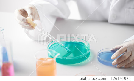 Hands Performing Scientific Experiments in a Modern Laboratory Setting. Hands Performing Scientific Experiments in a Modern Laboratory Setting. 126191923