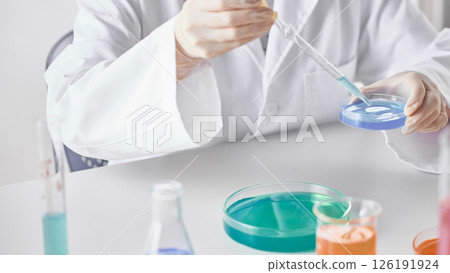 Hands Performing Scientific Experiments in a Modern Laboratory Setting. Hands Performing Scientific Experiments in a Modern Laboratory Setting. 126191924